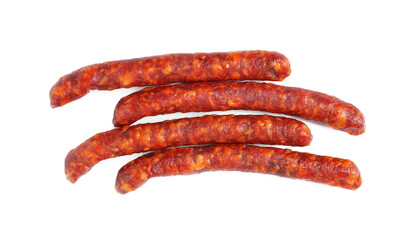 Many thin dry cured sausages isolated on white, top view