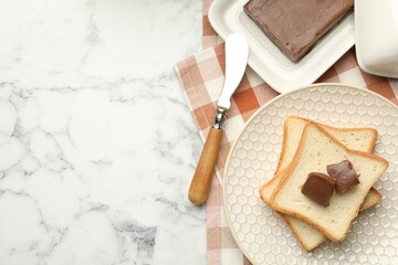 Sandwiches with chocolate butter and knife on white marble table, flat lay. Space for text