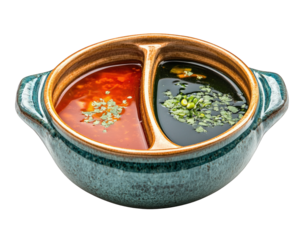 divided pot filled with two colorful broths, one red and one dark, garnished with herbs. Perfect for sharing and enjoying flavorful meal together