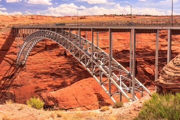 A bridge spans a canyon with a view of the desert