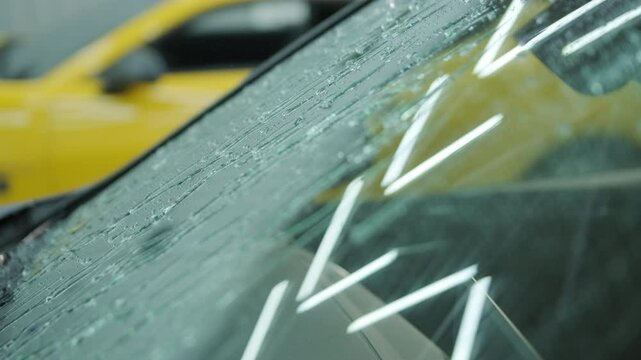 Water-repellent effect demonstration on a car hood after hydrophobic coating app