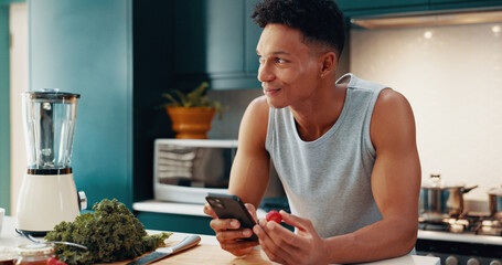 Phone, recipe and man with smoothie in kitchen for health, wellness and diet breakfast. Happy, cellphone and male person with vegetables and fruit for nutrition juice in morning at apartment.