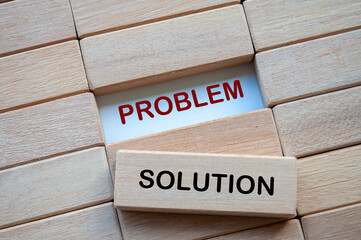 Problem and Solution text on wooden blocks representing problem solving business skill. Solution concept