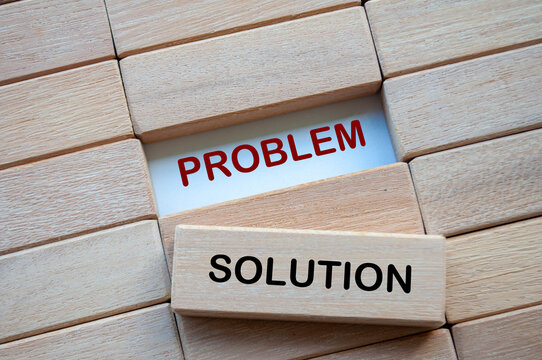 Problem and Solution text on wooden blocks representing problem solving business skill. Solution concept