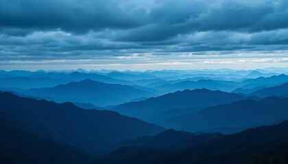 Fototapeta premium Majestic Blue Mountains Under a Dramatic Cloudy Sky: A Breathtaking Panoramic View of Endless Mountain Ranges