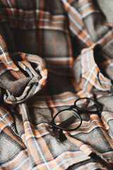 grey and brown plaid shirt with eye glasses
