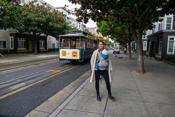 Mother and her child in front of cable car of San Fransicso
