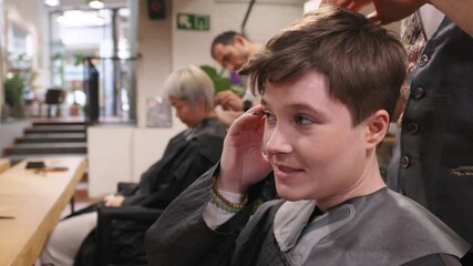 Stylist adjusting hair during professional salon appointment