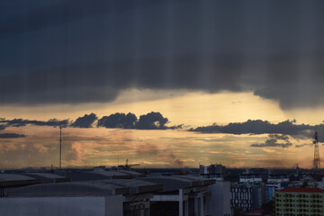 Nakhon Pathom, Thailand - April 30, 2015: Cityscape View Through Bird Protection Net in Morning Light with Urban Skyline and Cloudy Golden Sky at Mahidol University.