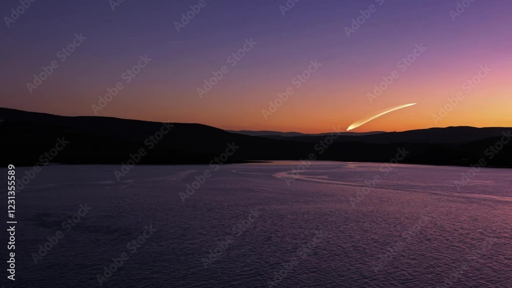 Aufkleber A panoramic view of a serene bay during a brilliant sunset, capturing the gentle waves and the glowing trail of a comet in the evening sky.
