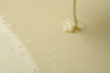 Pouring delicious condensed milk as background, closeup