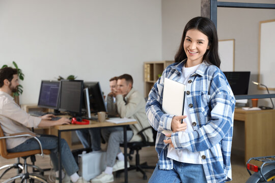 Female programmer with laptop in office