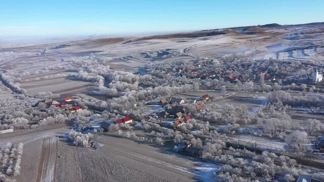 Aerial view of a misty countryside village, nature covered with hoarfrost