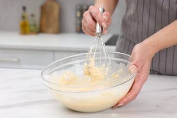 Woman making dough at white marble table indoors, closeup