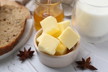 Sweet honey, butter, bread and milk on white table, closeup