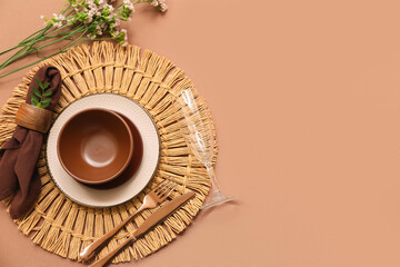 Beautiful table setting with gypsophila flowers and leaves on brown background
