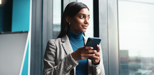 Thinking, window and woman with smartphone, office and employee with ideas for engagement and...
