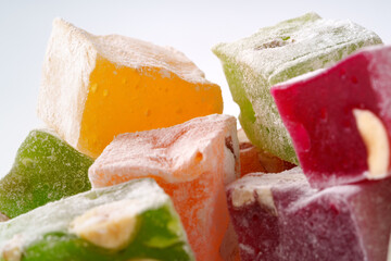 Colorful assortment of traditional Turkish delight with nuts and powdered sugar displayed attractively