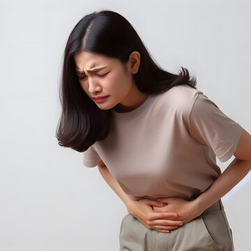 A Thailand woman clutches her stomach, indicating abdominal cramps or distress.