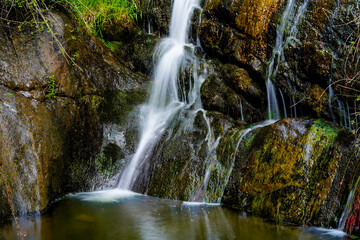 Water flowing from the mountain and creating silky waterfalls. Nature