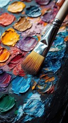 Obraz premium Close-up of an oil palette with various colors and brushes, showing the artist's tools and the texture of the oil paint.