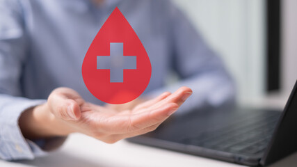 Professional health care worker doctor physician holding blood icon for blood donation concept