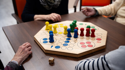 Four woman in a nursing home playing a board game