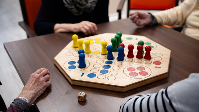 Four woman in a nursing home playing a board game