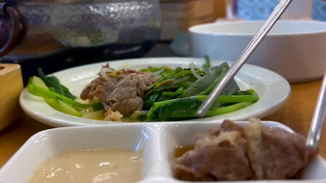 Tender shabu meat is dipped in a rich, spicy sauce to enhance the flavor. Creamy and spicy dipping sauces add depth, balance heat, and increase appetite. Concept flavor enhancer