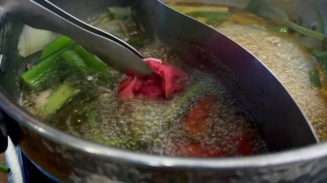  Japanese restaurant prepares the dish by dipping thinly sliced meat into boiling broth. This quick cooking method keeps the meat tender and flavorful. It is a traditional way of cooking mea