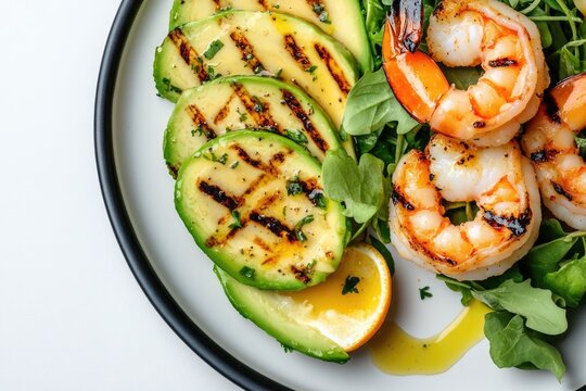 Grilled shrimp paired with vibrant avocado slices and fresh gree