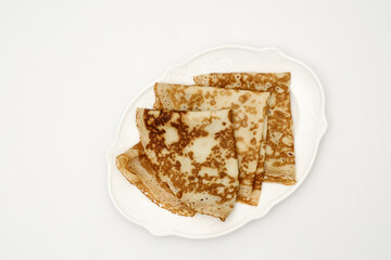 Sweet crepes on white background. Homemade food concept. Top view, flat lay