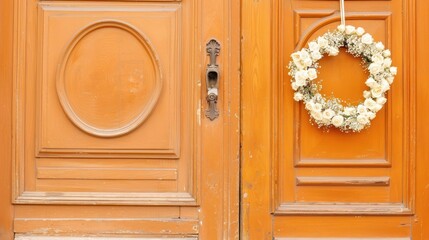 White Floral Wreath Hanging on a Rustic Orange Wooden Door with Detailed Knob, showcasing Charming Home Decoration and Seasonal Ambiance