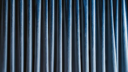 Obraz premium Luxurious blue velvet curtains create a sophisticated abstract backdrop with rich texture in a calming arrangement of vertical drapes.