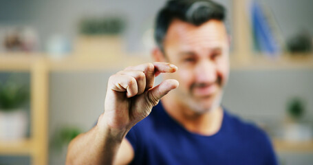 Man, hands and sign for small size, measurement or emoji in creative startup. Fingers, pinch and...