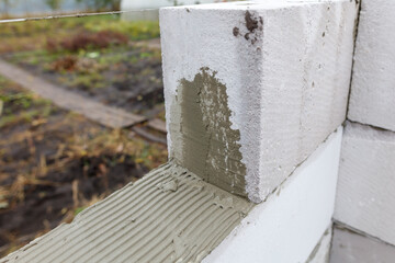 A white brick wall with a brown trowel on it