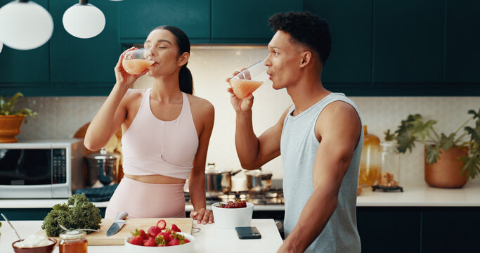 Couple, drinking and juice of fitness at house of healthy meal, nutrition diet and bonding together. People, cooking and vegan drink of gut health, morning detox and weight loss of brunch ingredients