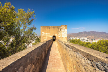Castle of Gibralfaro in Malaga city at Andalusia, Spain, Europe. Ancient stone pathway leading to a...