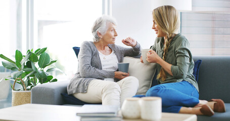 Elderly mother, woman and relax with coffee for conversation, gossip story and weekend visit in home. Senior person, daughter or tea time in living room sofa for bonding, love or healthy relationship