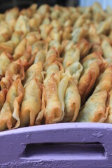A typical Indonesian food called martabak is in a container on a wooden table

