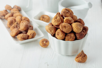 Organic dried figs on a white table.