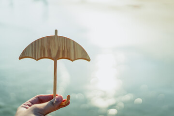 Hand of man holding an umbrella symbol. Insurance concept, Family life insurance and policy concepts