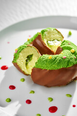 A whimsical and colorful dessert donut is displayed on a pristine white plate.