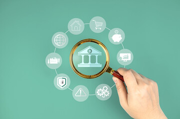 Online banking concept. Bank icon in magnifying glass with financial icons. financial management...