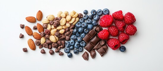 Assorted almonds, hazelnuts, blueberries, raspberries, and dark chocolate pieces arranged in a colorful top view on a clean white background