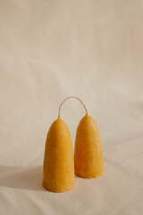 Thick beeswax candles made by hand on a light fabric background
