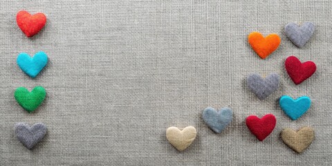Obraz premium Colorful Felt Hearts Arranged on Textured Fabric Background