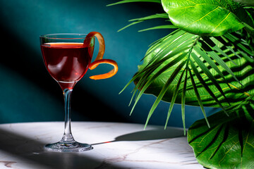 Bijou alcoholic cocktail drink with gin, sweet vermouth, liqueur and orange bitters. Marble table,...