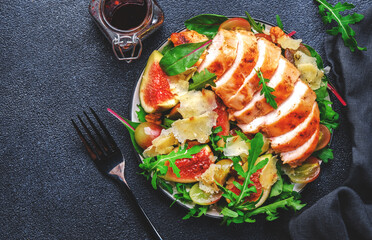 Gourmet lunch with figs, chicken, cheese, grape and herbs. Black background, top view