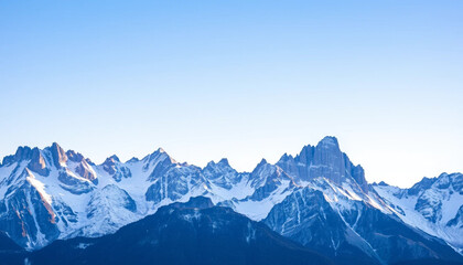 Obraz premium a dramatic mountain range with snow-capped peaks under a clear sky